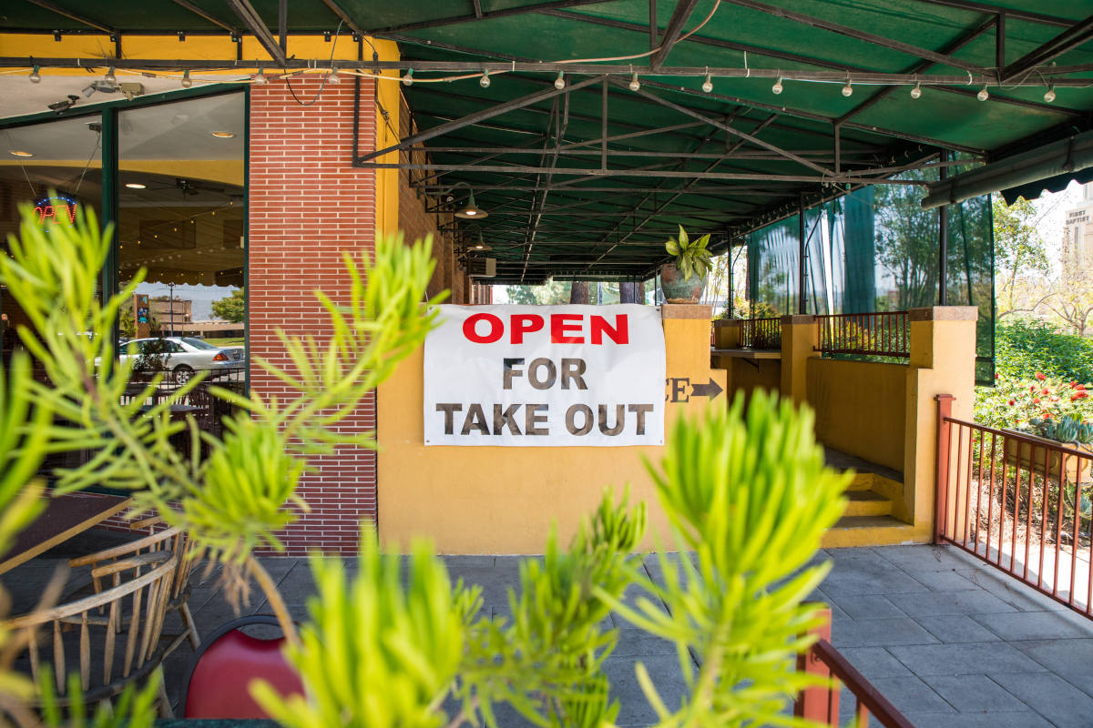 Restaurant entrance, open for take out sign
